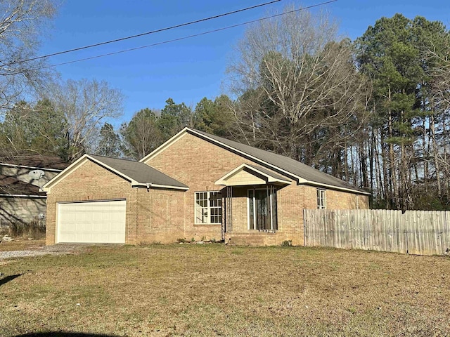 view of front of property with a front yard and a garage