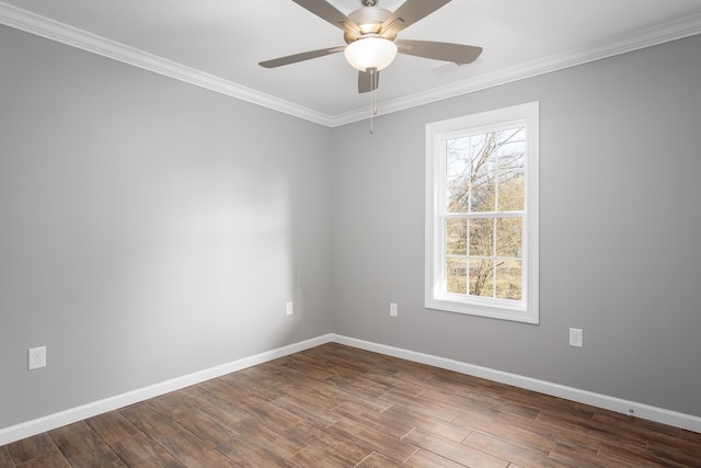 spare room featuring baseboards, wood finished floors, and ornamental molding