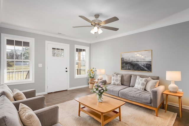 living room with a ceiling fan, crown molding, wood finished floors, and baseboards