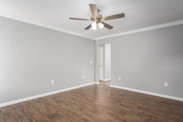 empty room featuring dark wood-type flooring, crown molding, baseboards, and ceiling fan