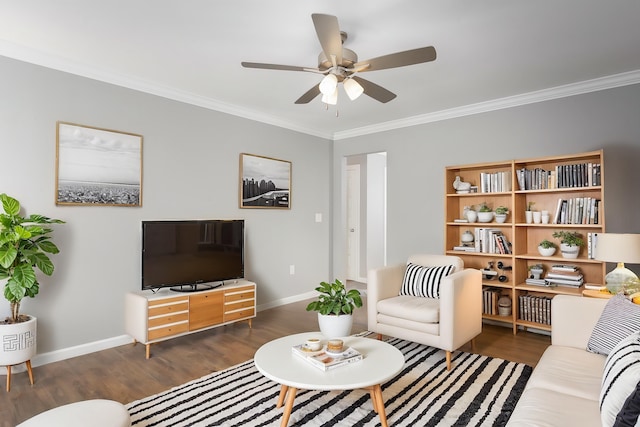 living room featuring a ceiling fan, crown molding, wood finished floors, and baseboards