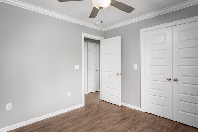 unfurnished bedroom featuring wood finished floors, baseboards, and ornamental molding