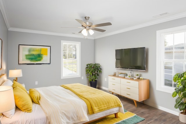 bedroom with dark wood finished floors, visible vents, multiple windows, and ornamental molding