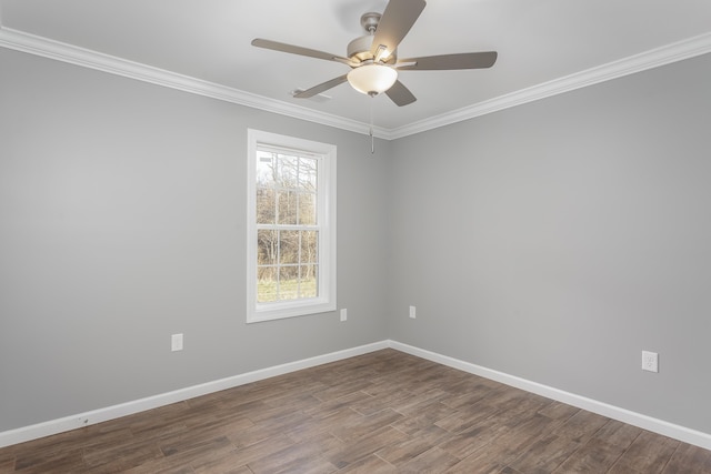 unfurnished room featuring dark wood finished floors, ceiling fan, crown molding, and baseboards