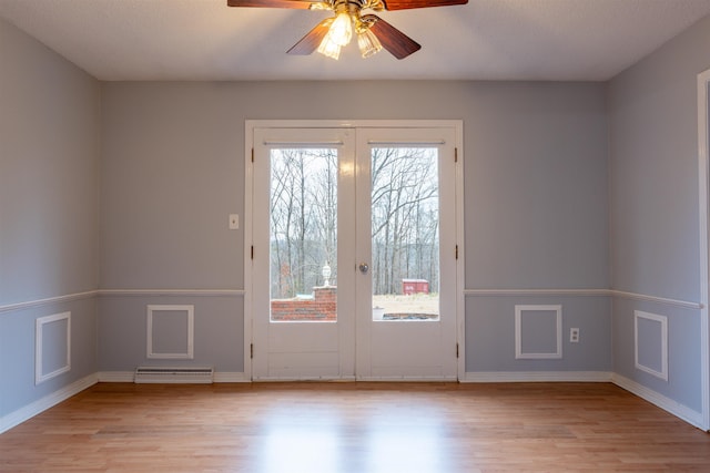 interior space with ceiling fan, light wood-type flooring, and french doors