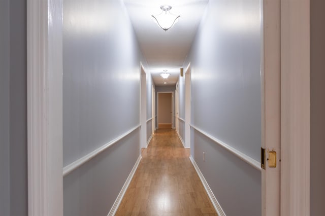 corridor featuring wood-type flooring