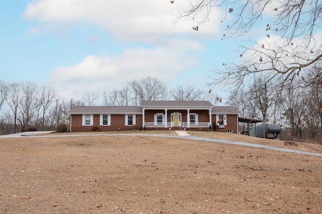 ranch-style house with a carport and a porch