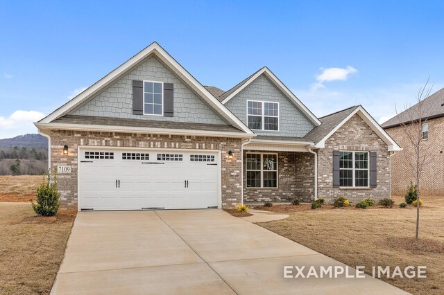 craftsman inspired home featuring a garage, brick siding, driveway, and roof with shingles