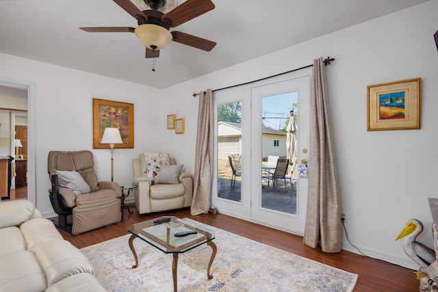 living room featuring hardwood / wood-style floors and ceiling fan