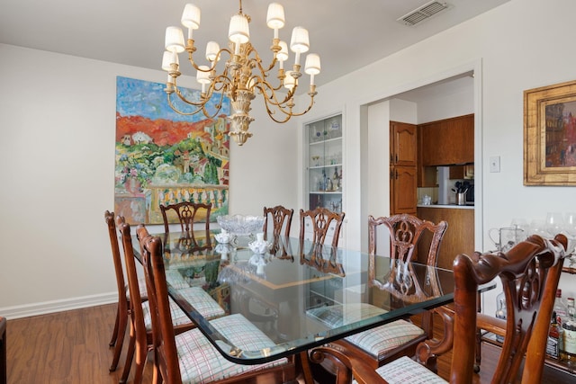 dining room featuring dark wood-type flooring and a chandelier