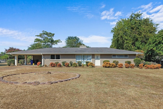 ranch-style home with a front yard and a carport