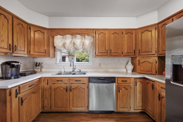 kitchen with backsplash, dark hardwood / wood-style flooring, sink, and appliances with stainless steel finishes