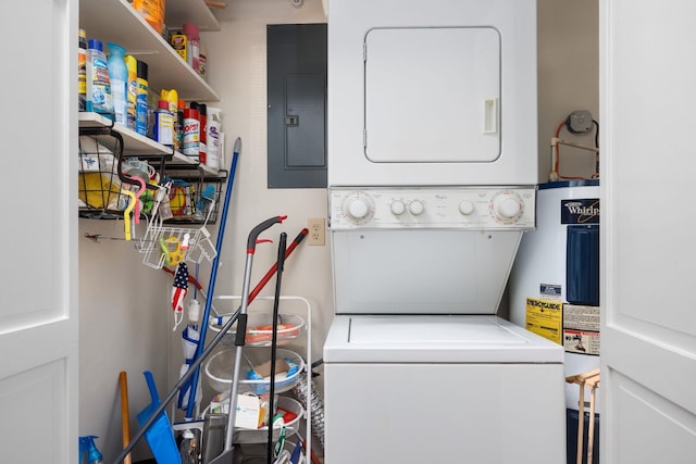 laundry area featuring electric panel, water heater, and stacked washer and clothes dryer