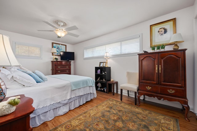 bedroom with ceiling fan and wood-type flooring