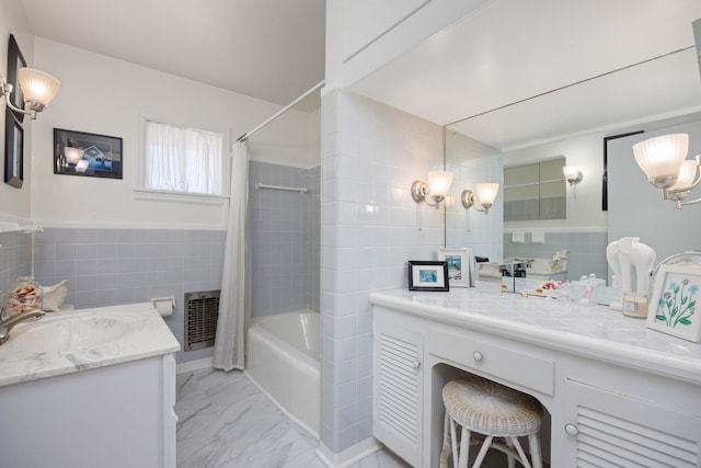 bathroom featuring tile walls, vanity, and shower / tub combo