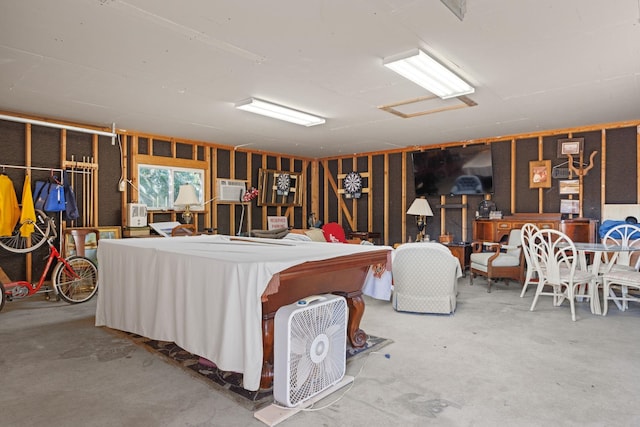 miscellaneous room featuring a wall unit AC and concrete flooring