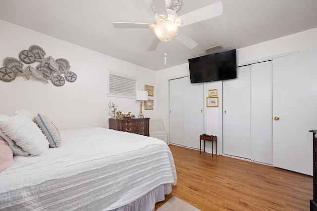 bedroom with light wood-type flooring, a closet, and ceiling fan