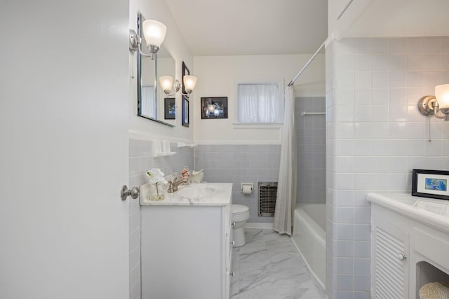 full bathroom featuring vanity, heating unit, shower / bathtub combination with curtain, tile walls, and toilet