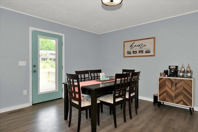  - dining room with crown molding, wood finished floors, and baseboards