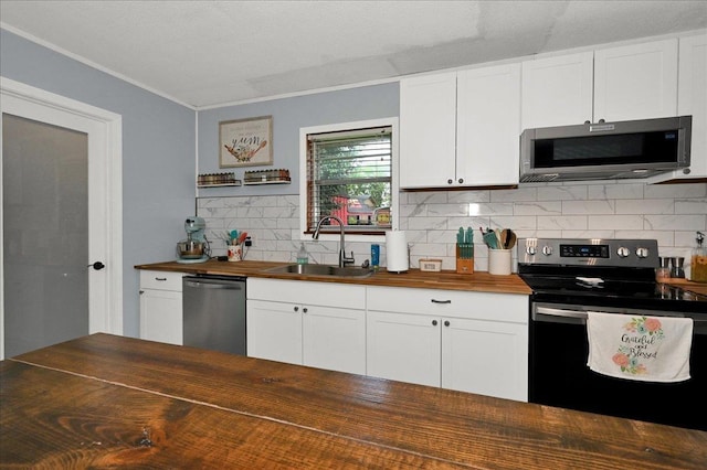 - kitchen featuring wooden counters, stainless steel appliances, a sink, backsplash, and crown molding