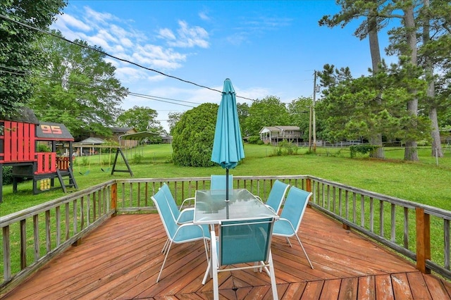  - wooden terrace featuring a playground and outdoor dining space