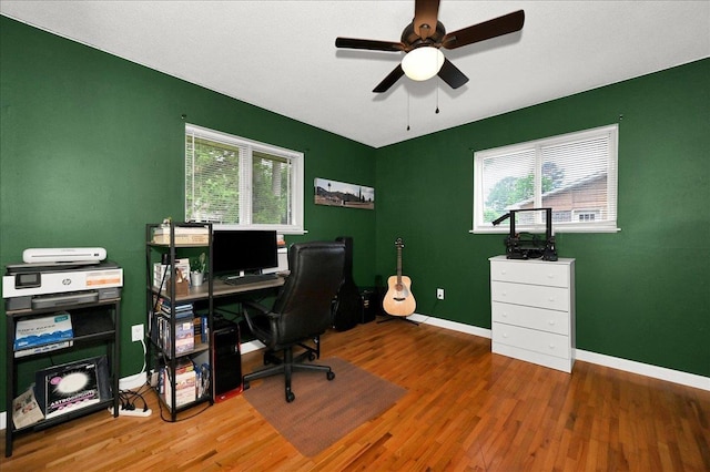  - home office featuring wood finished floors, ceiling fan, and baseboards