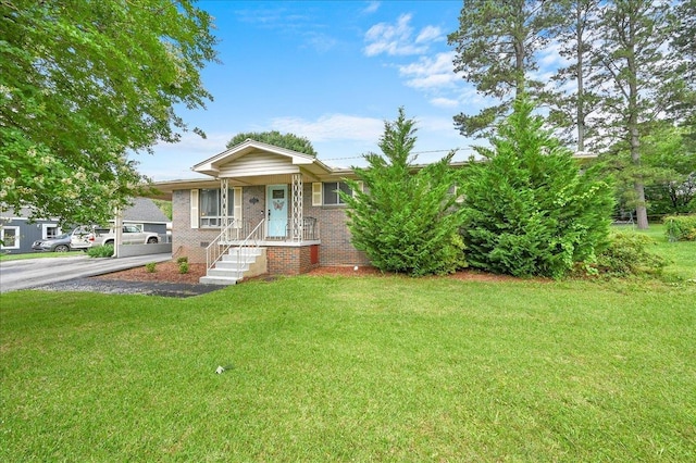 - view of front facade featuring a front lawn and brick siding
