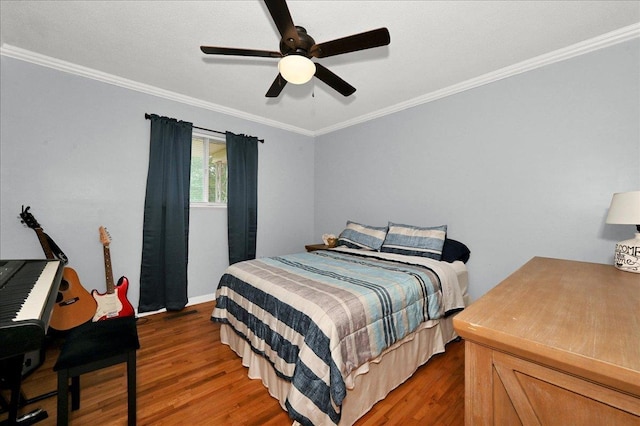  - bedroom with wood finished floors, ornamental molding, a ceiling fan, and baseboards
