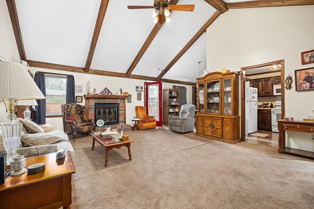 living room featuring beamed ceiling, ceiling fan, high vaulted ceiling, and a brick fireplace