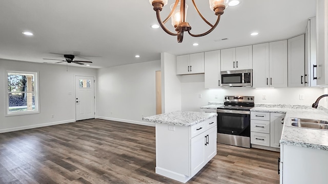 kitchen with sink, white cabinetry, hanging light fixtures, a kitchen island, and stainless steel appliances