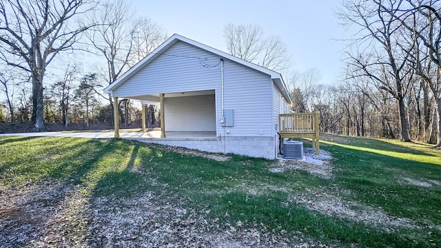 view of home's exterior with a lawn, central air condition unit, and a deck