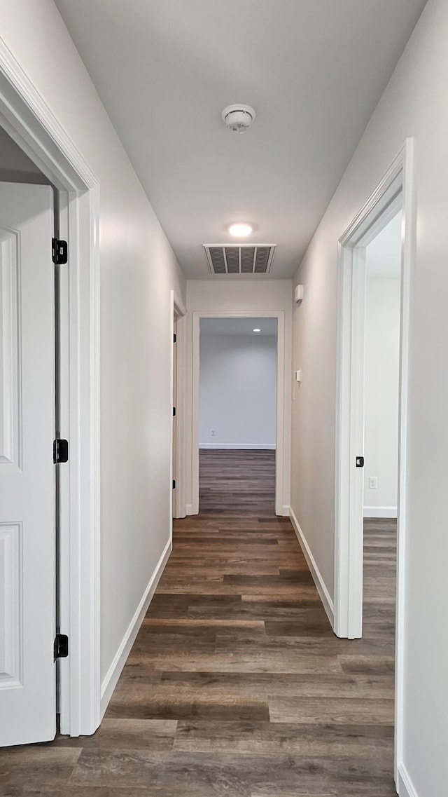 hall with dark hardwood / wood-style flooring