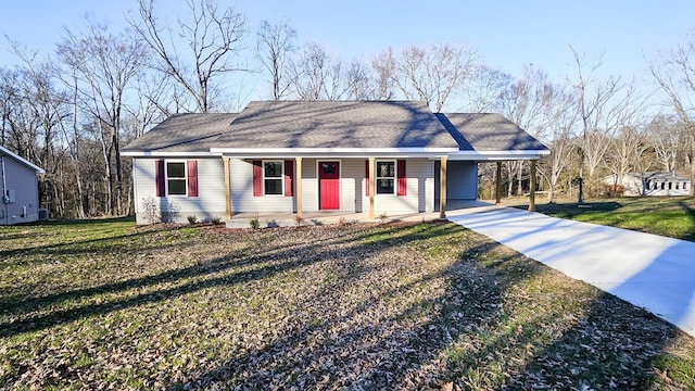 ranch-style home featuring a carport, covered porch, and a front lawn