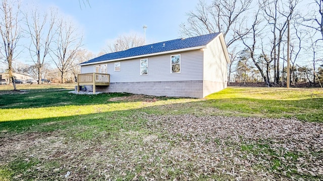 view of home's exterior with a wooden deck and a yard