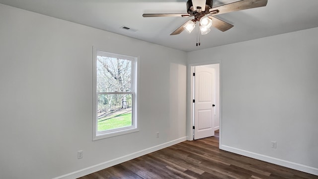 unfurnished room with ceiling fan and dark hardwood / wood-style flooring