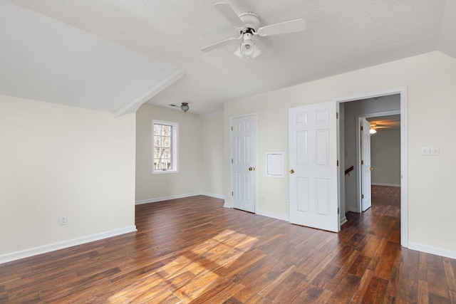 additional living space featuring ceiling fan, dark hardwood / wood-style floors, and a textured ceiling