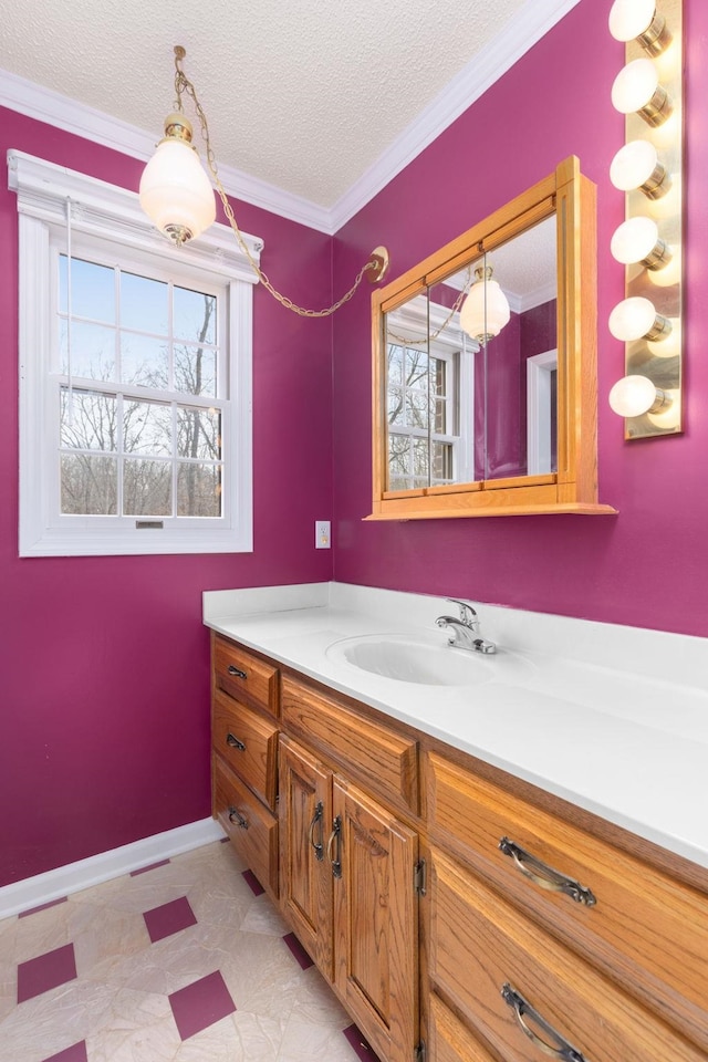 bathroom with vanity, ornamental molding, and a textured ceiling