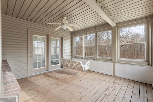 unfurnished sunroom with ceiling fan