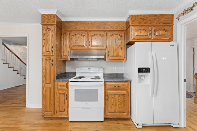 kitchen with white appliances, extractor fan, and light wood-type flooring