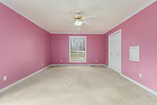 empty room with crown molding, ceiling fan, and light carpet