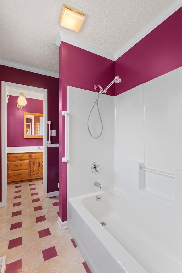 bathroom with vanity, tub / shower combination, crown molding, and a textured ceiling