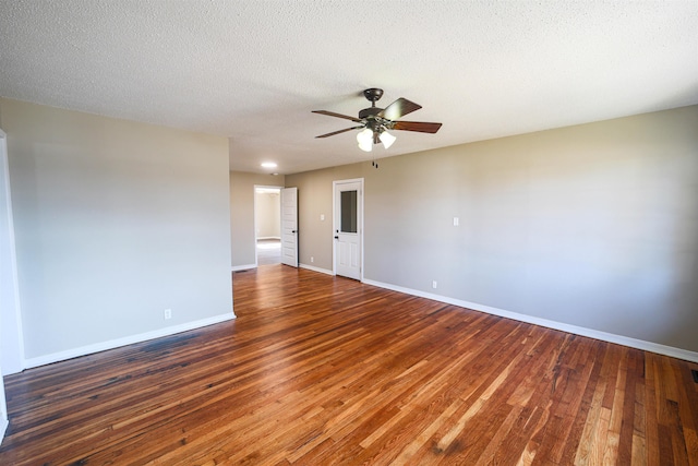 spare room with a textured ceiling, dark hardwood / wood-style floors, and ceiling fan