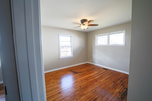 unfurnished room with hardwood / wood-style flooring and ceiling fan