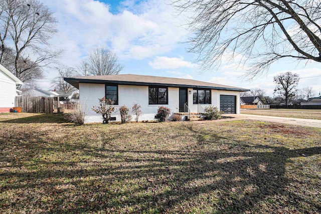 ranch-style house with a garage and a front lawn