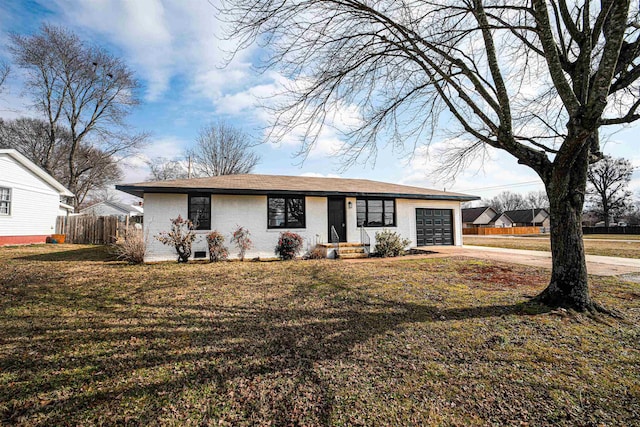 ranch-style home with a garage and a front lawn