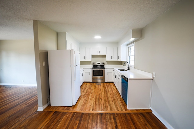 kitchen featuring sink, dishwasher, white refrigerator, white cabinets, and stainless steel electric stove