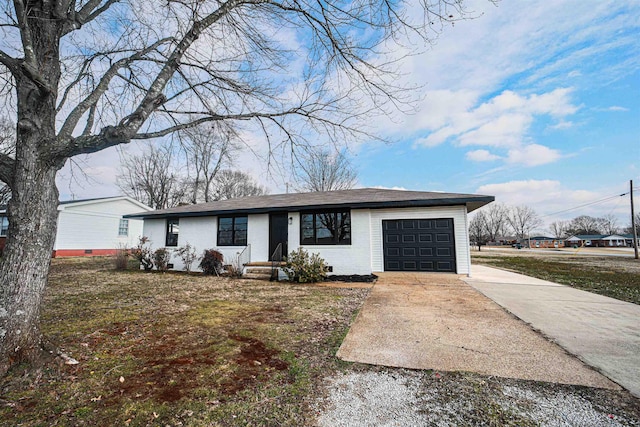 ranch-style house featuring a garage and a front lawn