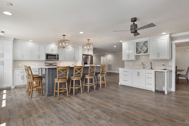 kitchen featuring appliances with stainless steel finishes, light countertops, and white cabinetry