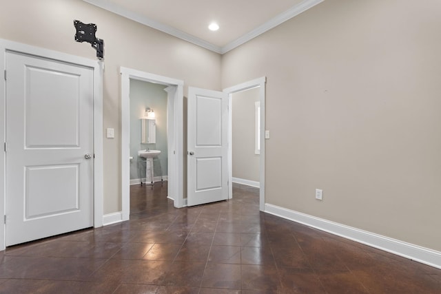 unfurnished room with recessed lighting, baseboards, a sink, and ornamental molding