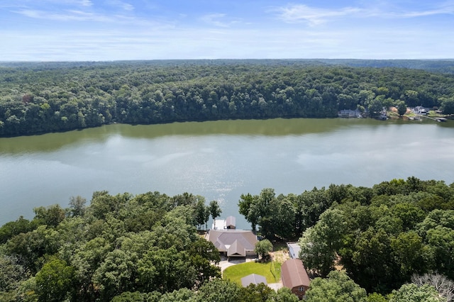 drone / aerial view with a forest view and a water view